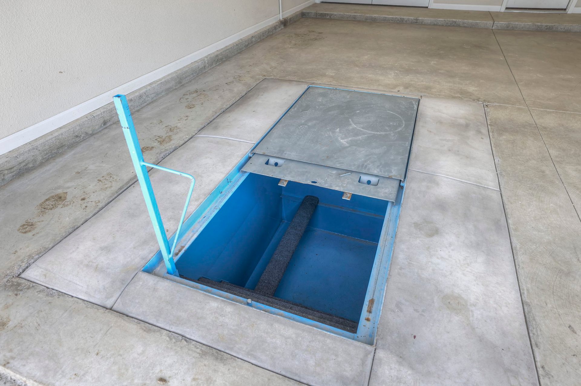 In-ground storm shelter installed in an Oak Ridge Homes garage